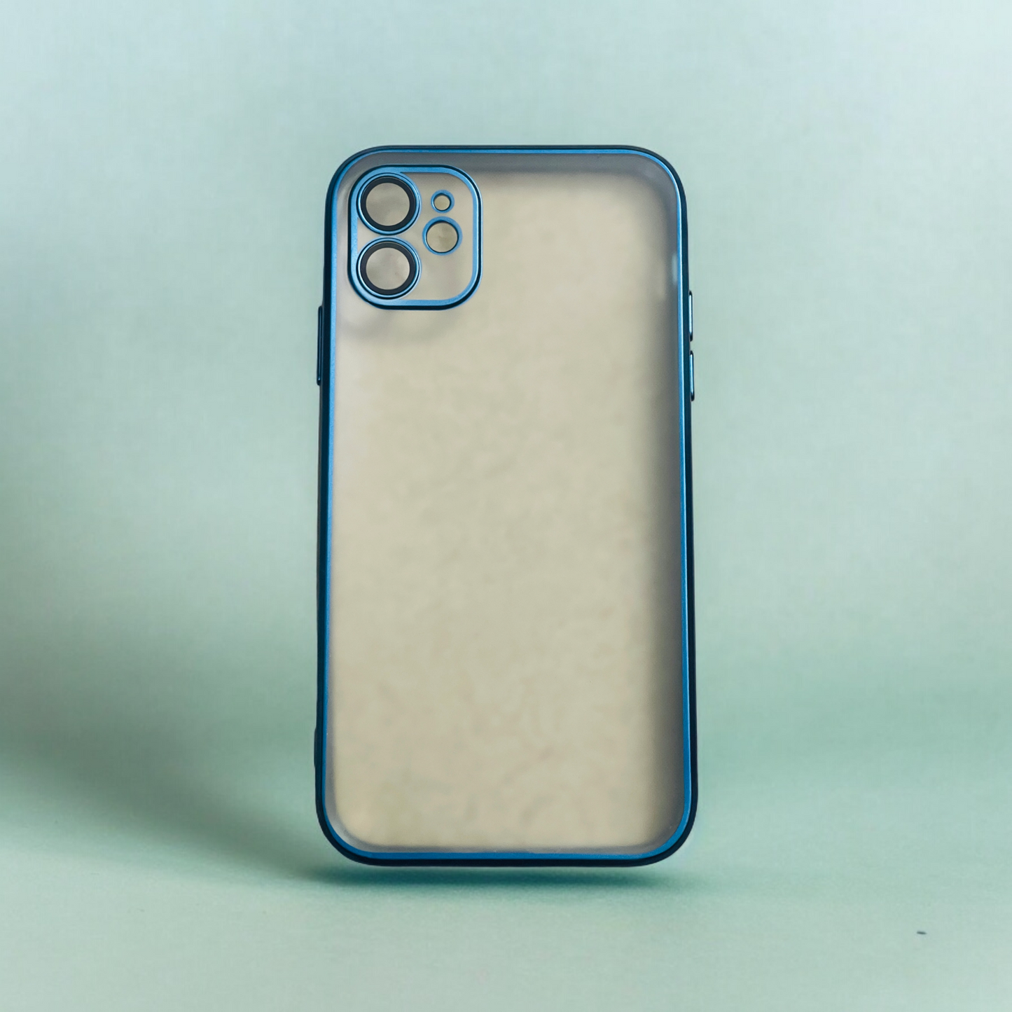 A Zivikart Elegant Electroplated Case with Camera Protection for Apple iPhone is positioned upright against a light green gradient background. The case features a blue border and an eye-catching electroplated finish. Its camera setup includes three lenses and a flash in an upper corner, ensuring excellent protection for the camera. The overall design is minimalistic and sleek.